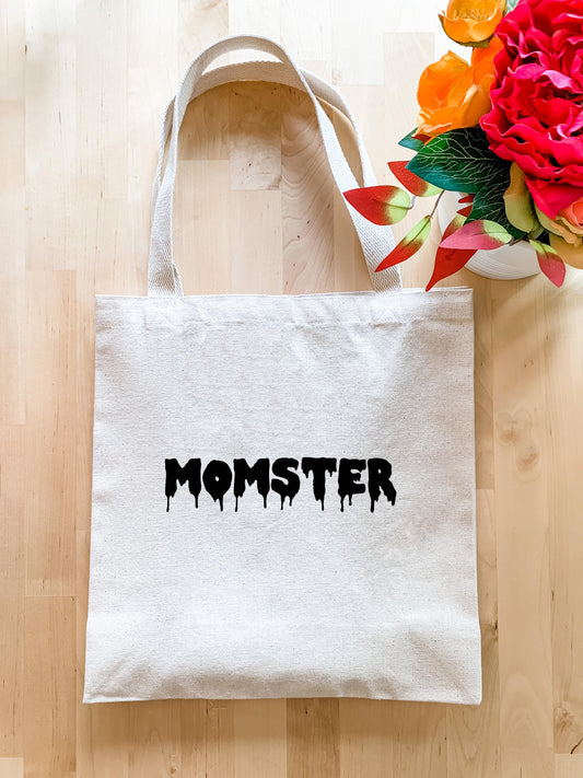 a white tote bag with the word monster painted on it