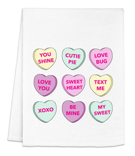 a white tea towel with conversation hearts on it
