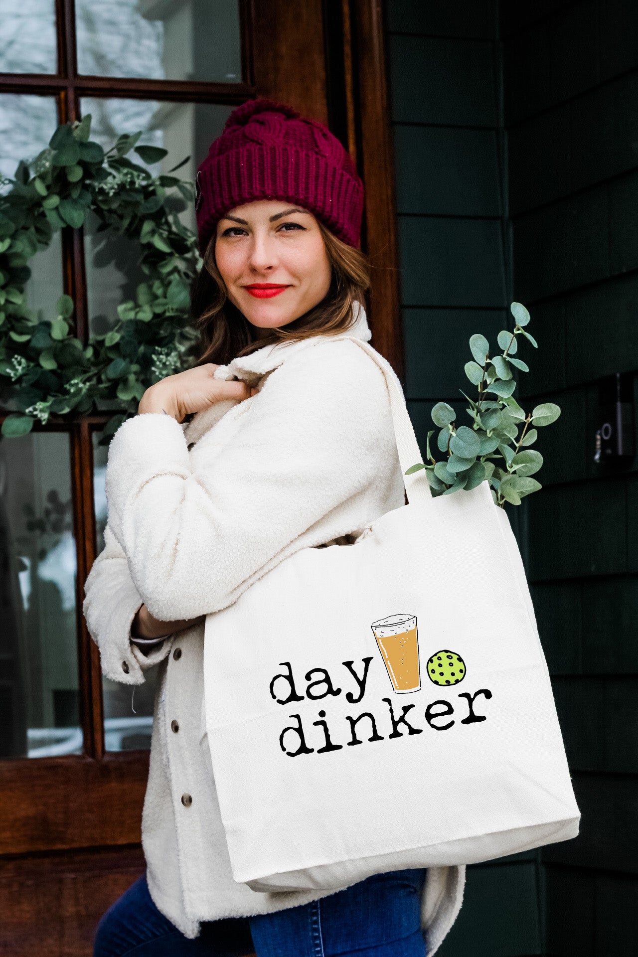 a woman carrying a bag that says day drinker