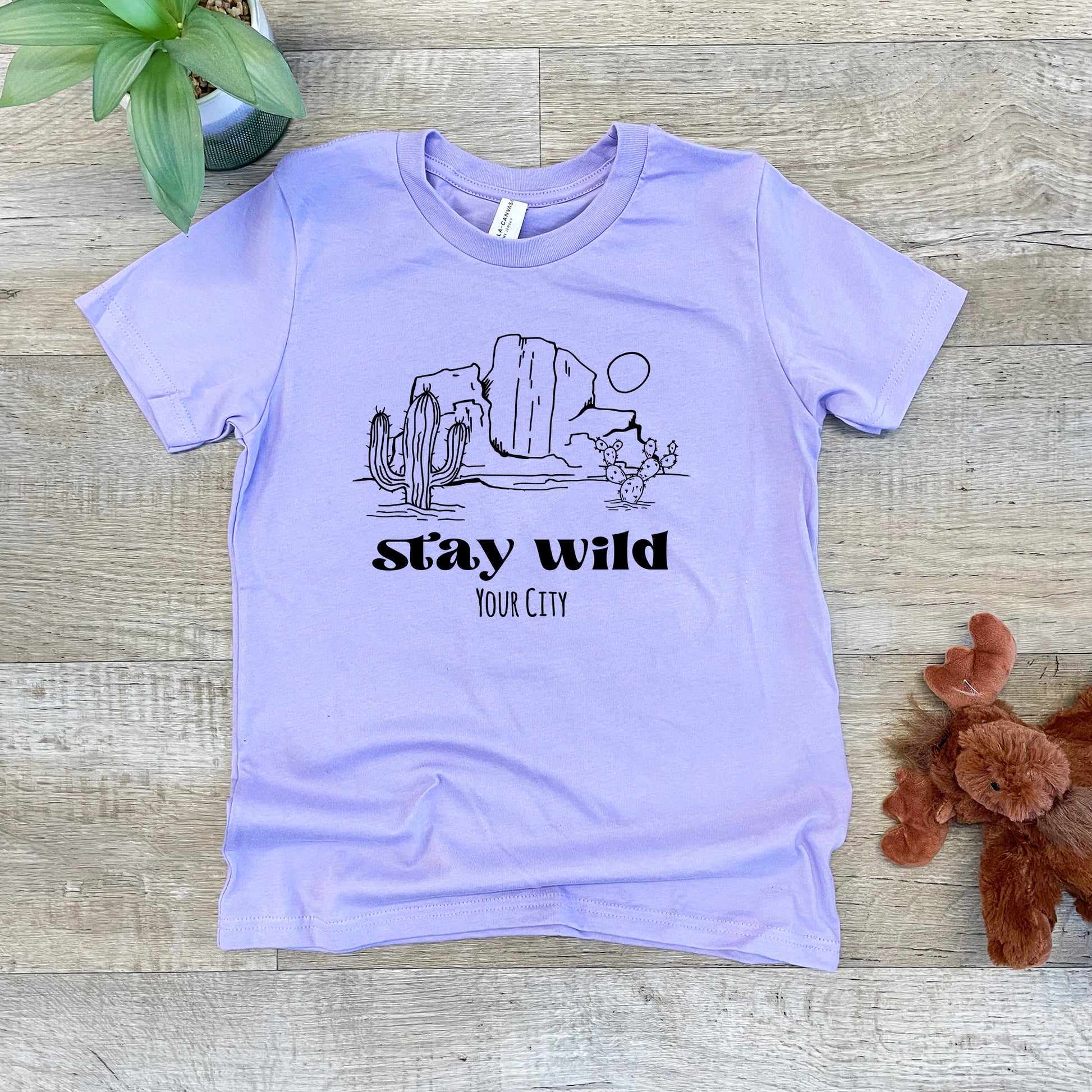 a t - shirt that says stay wild in front of a teddy bear