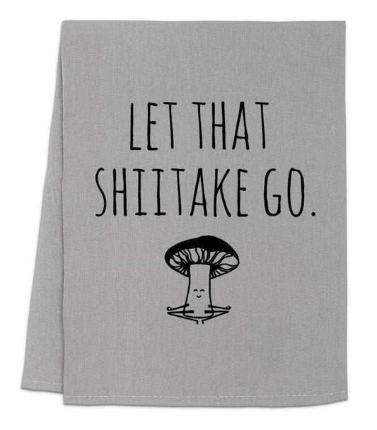 a towel with a mushroom on it that says let that shiitake go