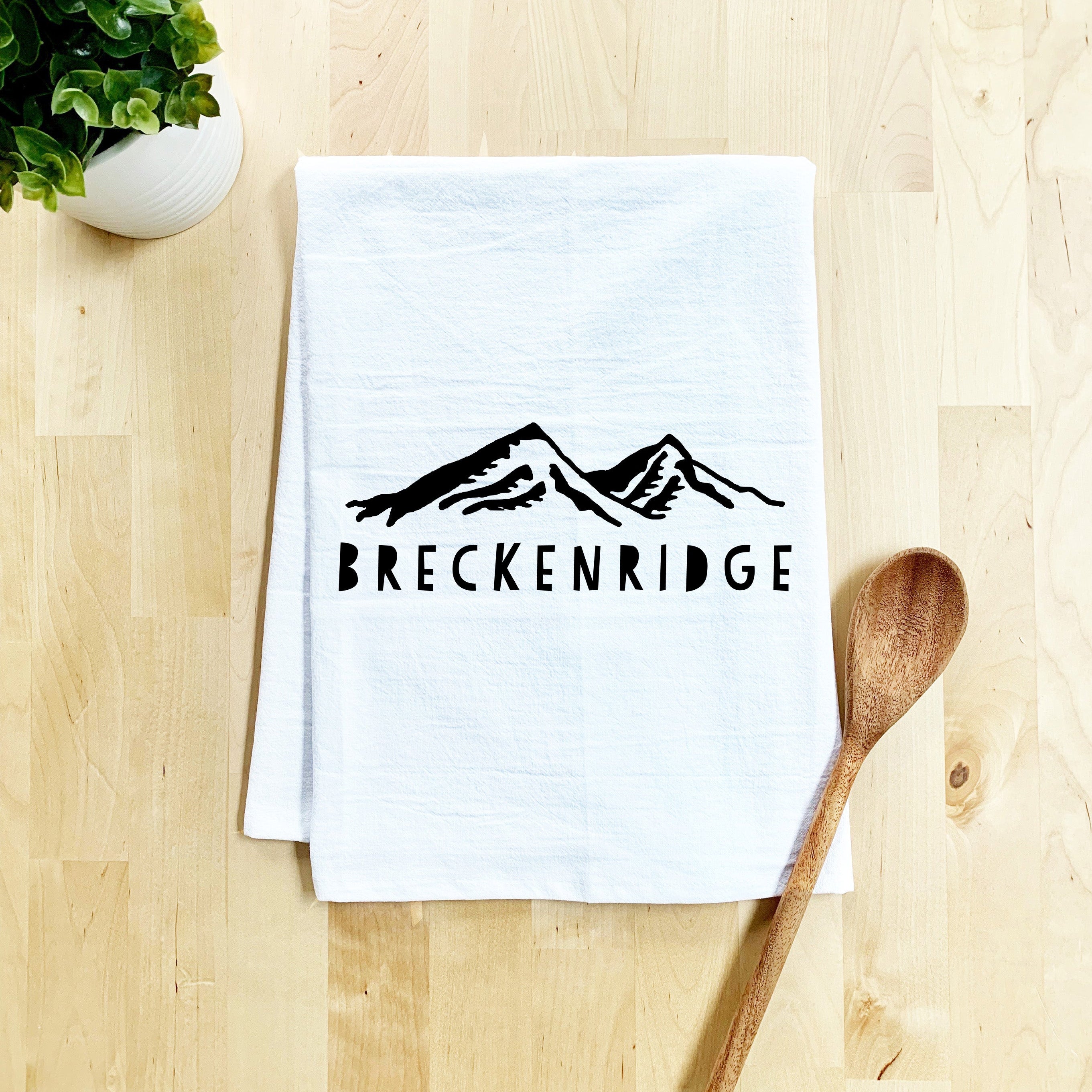 a tea towel with a wooden spoon on a table