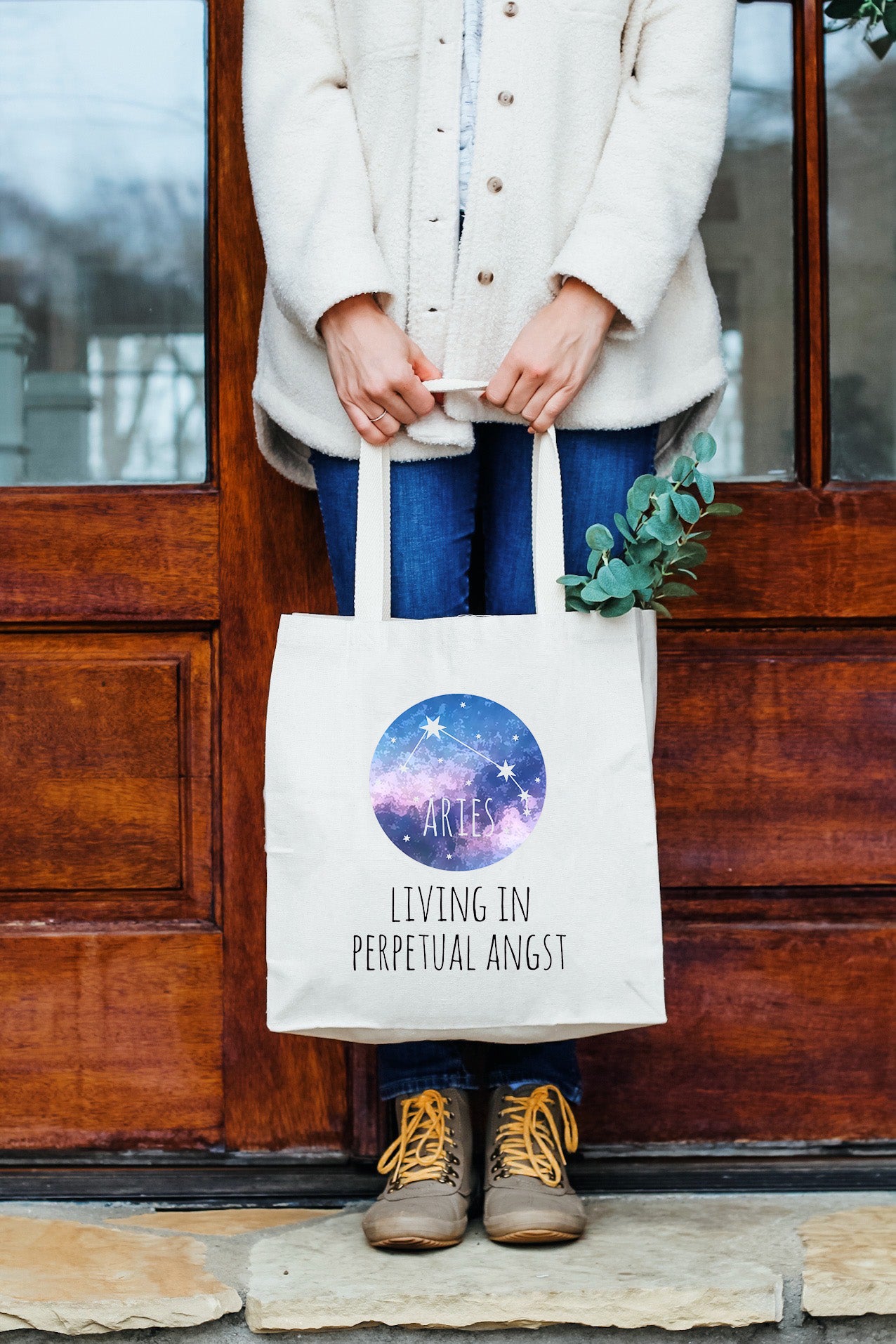 a woman holding a white shopping bag with the words living in perpetual anger