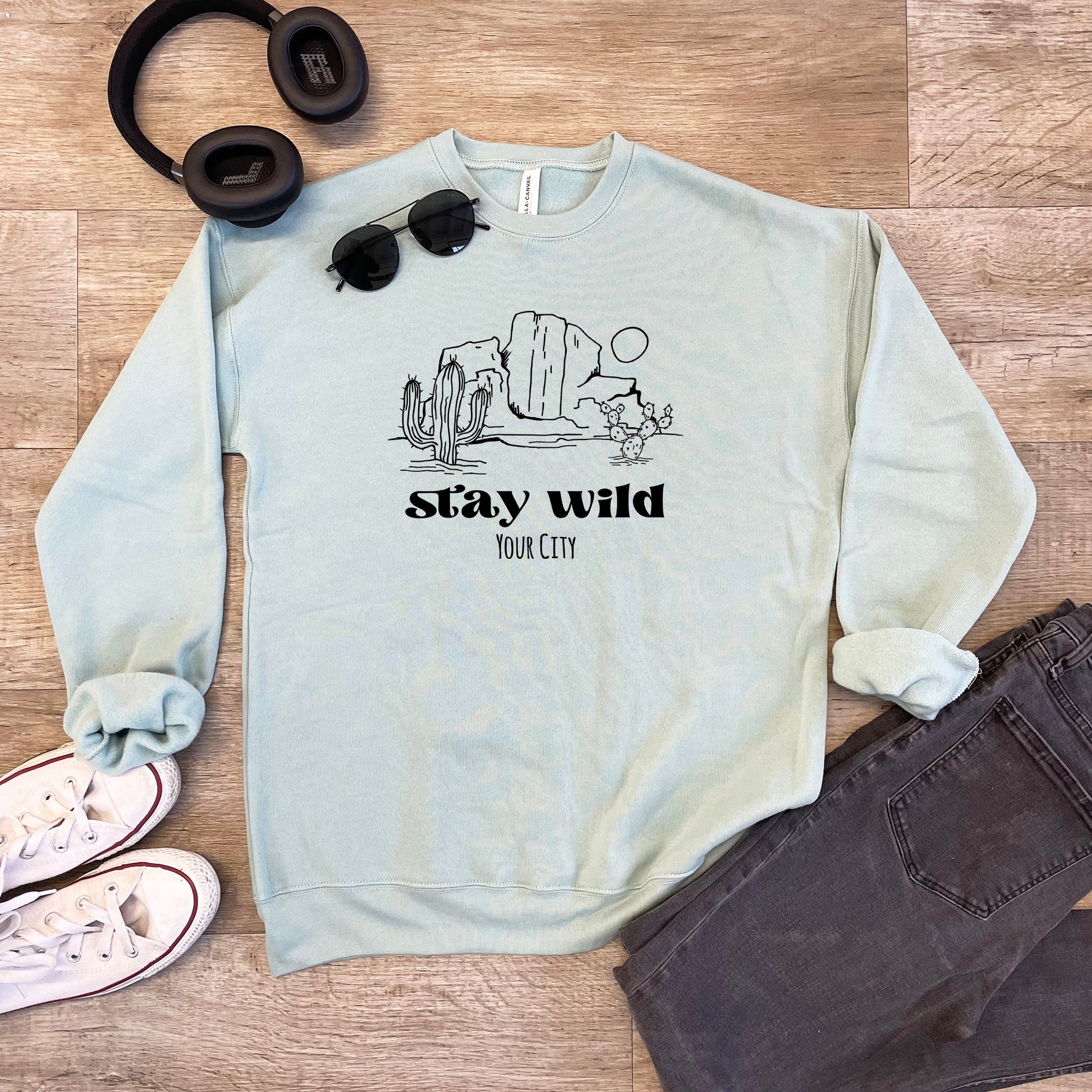 a sweatshirt with a pair of headphones and a pair of sunglasses