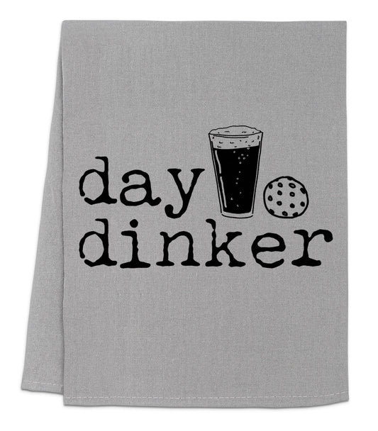 a gray towel with a glass of beer and cookie on it