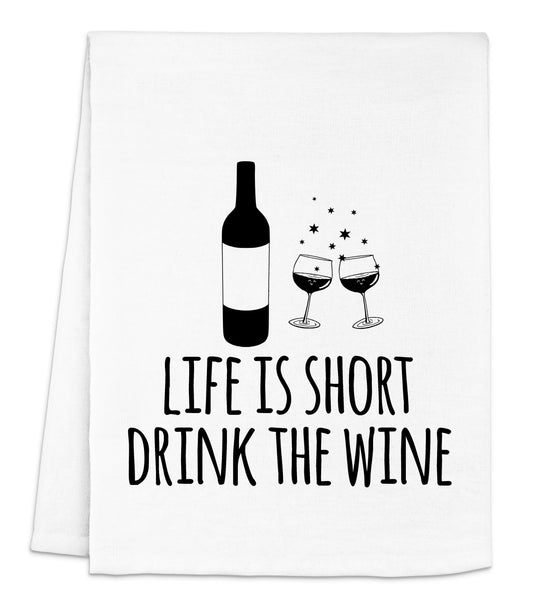 a white dish towel with a bottle of wine and two glasses of wine