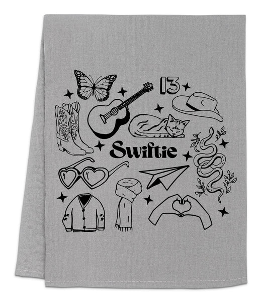 a gray towel with a black and white picture of a guitar and other items