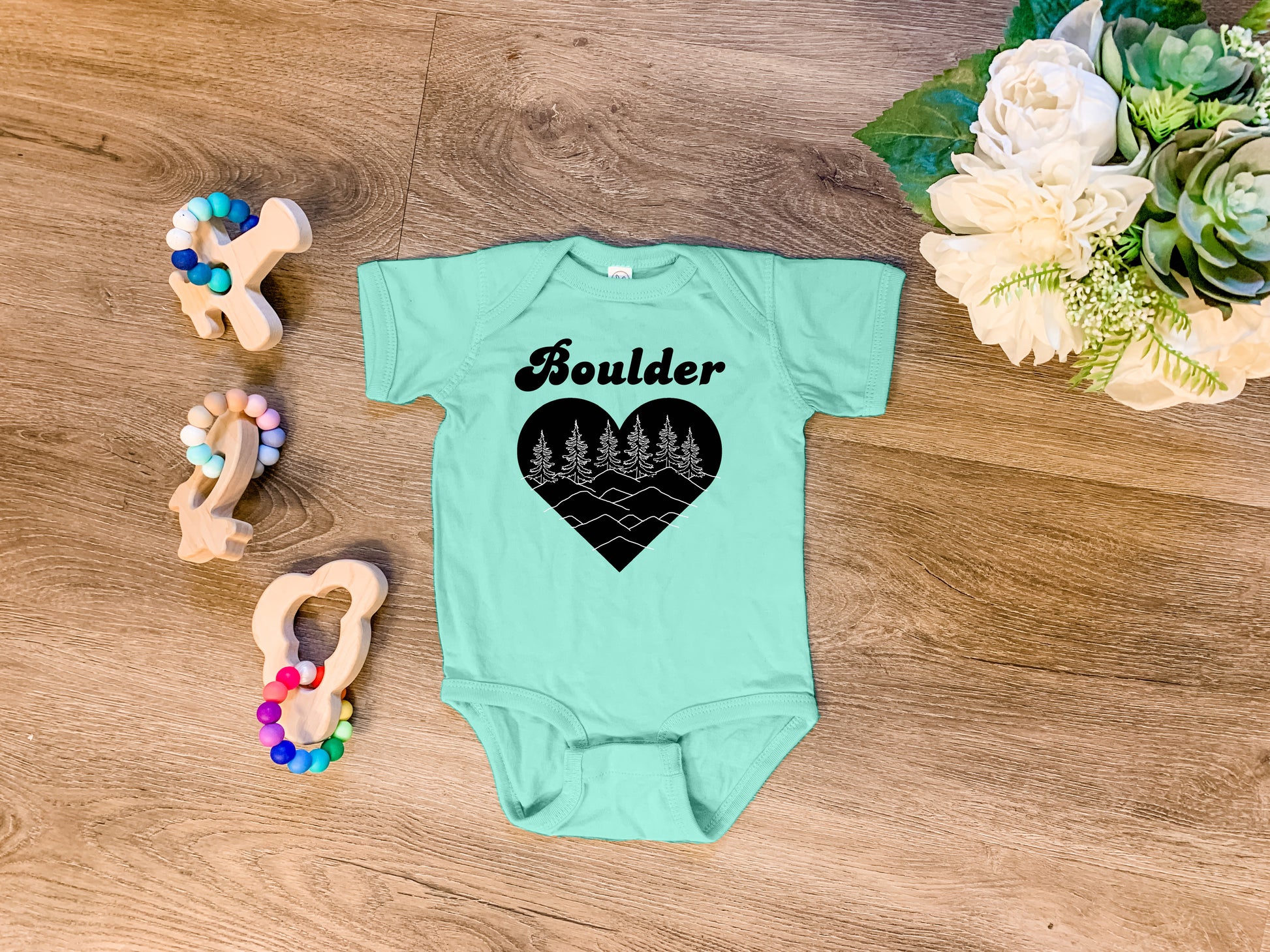 a baby bodysuit with the word boulder written on it