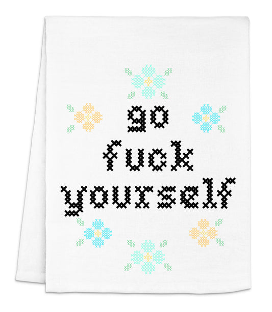 a white dish towel with a cross - stitch design on it