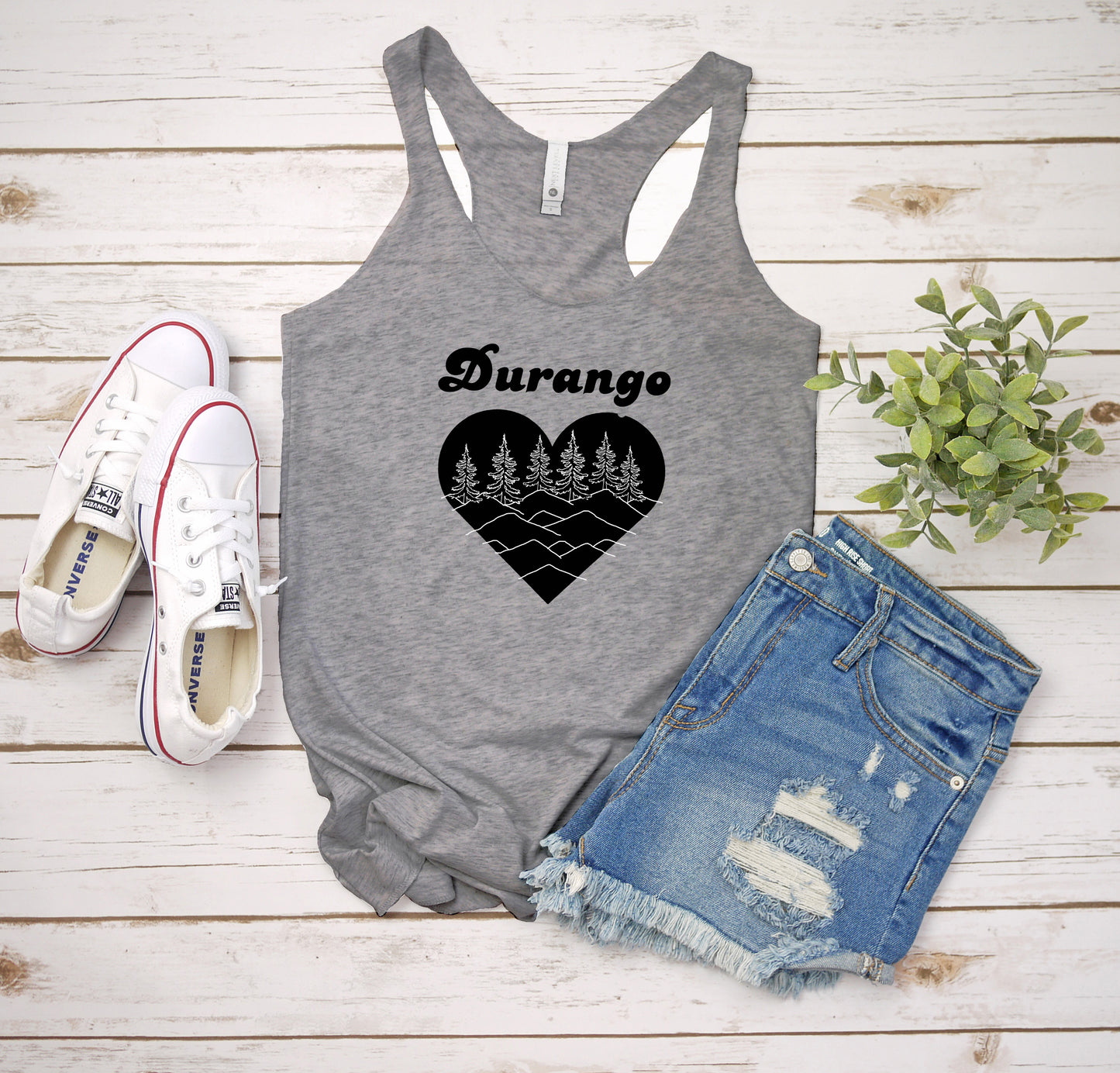 a women's tank top with a heart and trees on it