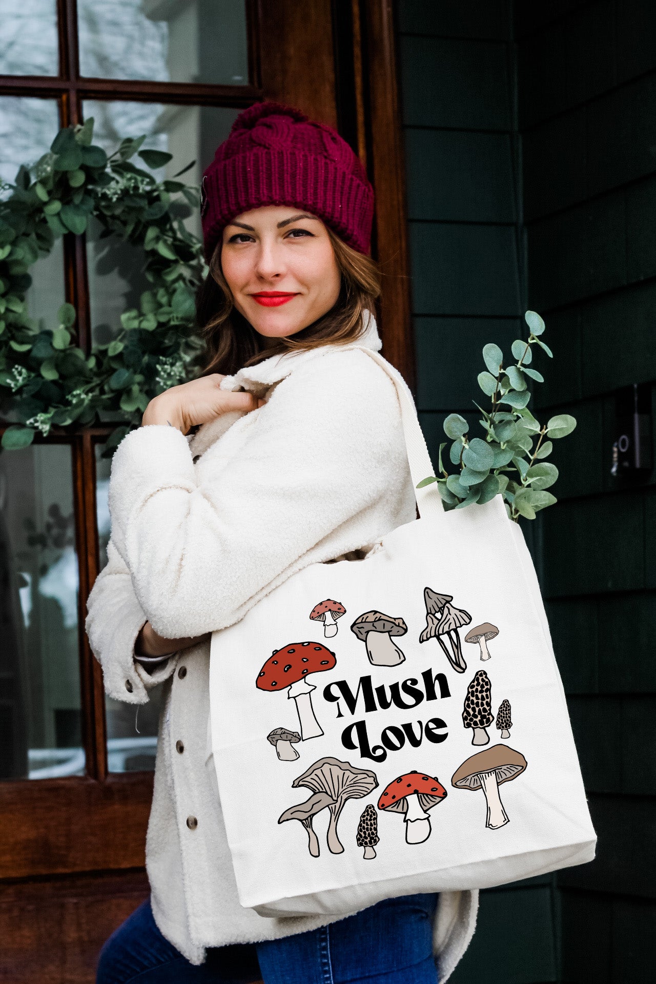 a woman carrying a bag with mushrooms on it