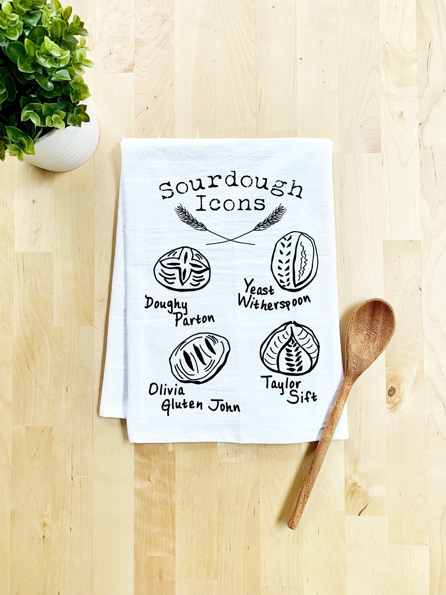a tea towel with a spoon on a wooden table