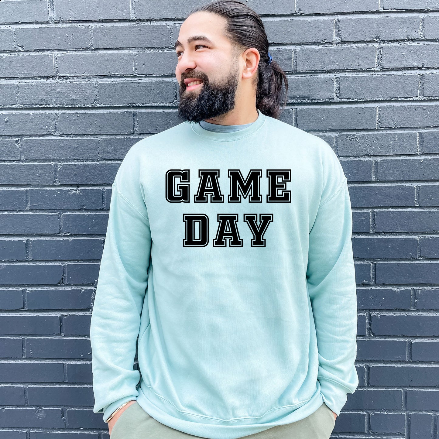 a man with a beard wearing a game day sweatshirt