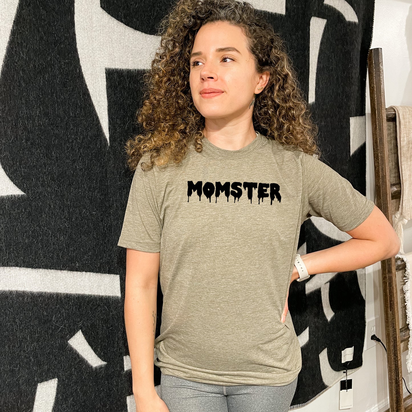 a woman standing in front of a monster sign