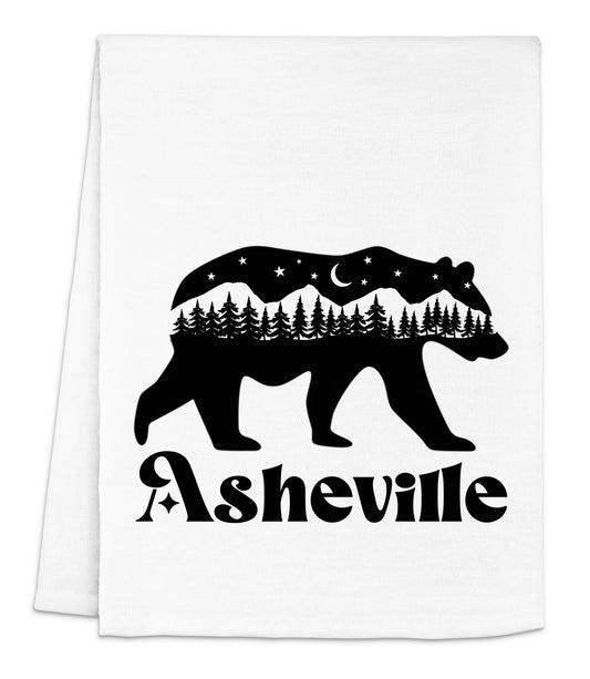 a white dish towel with a bear and trees on it