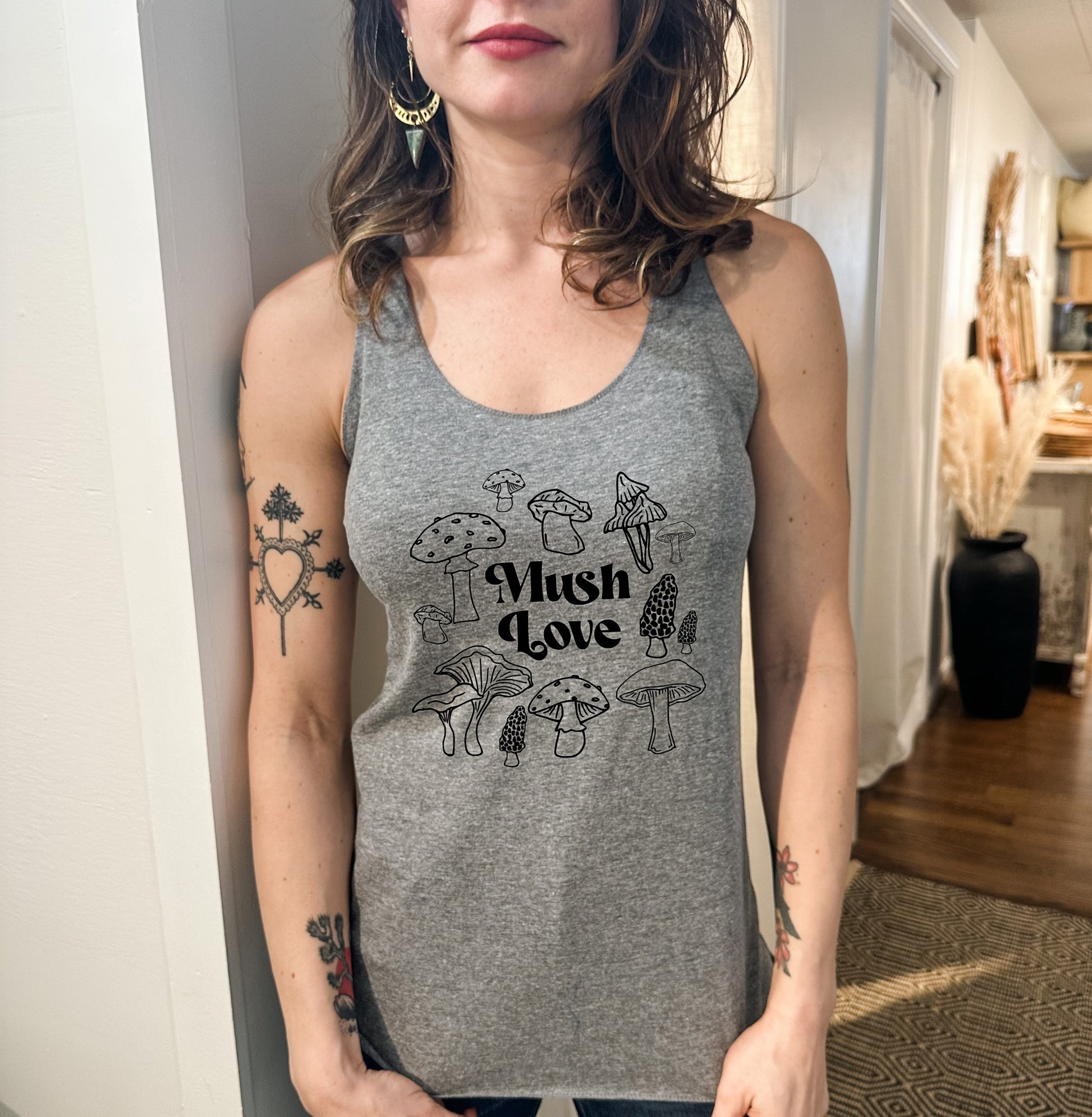 a woman wearing a tank top that says mush love