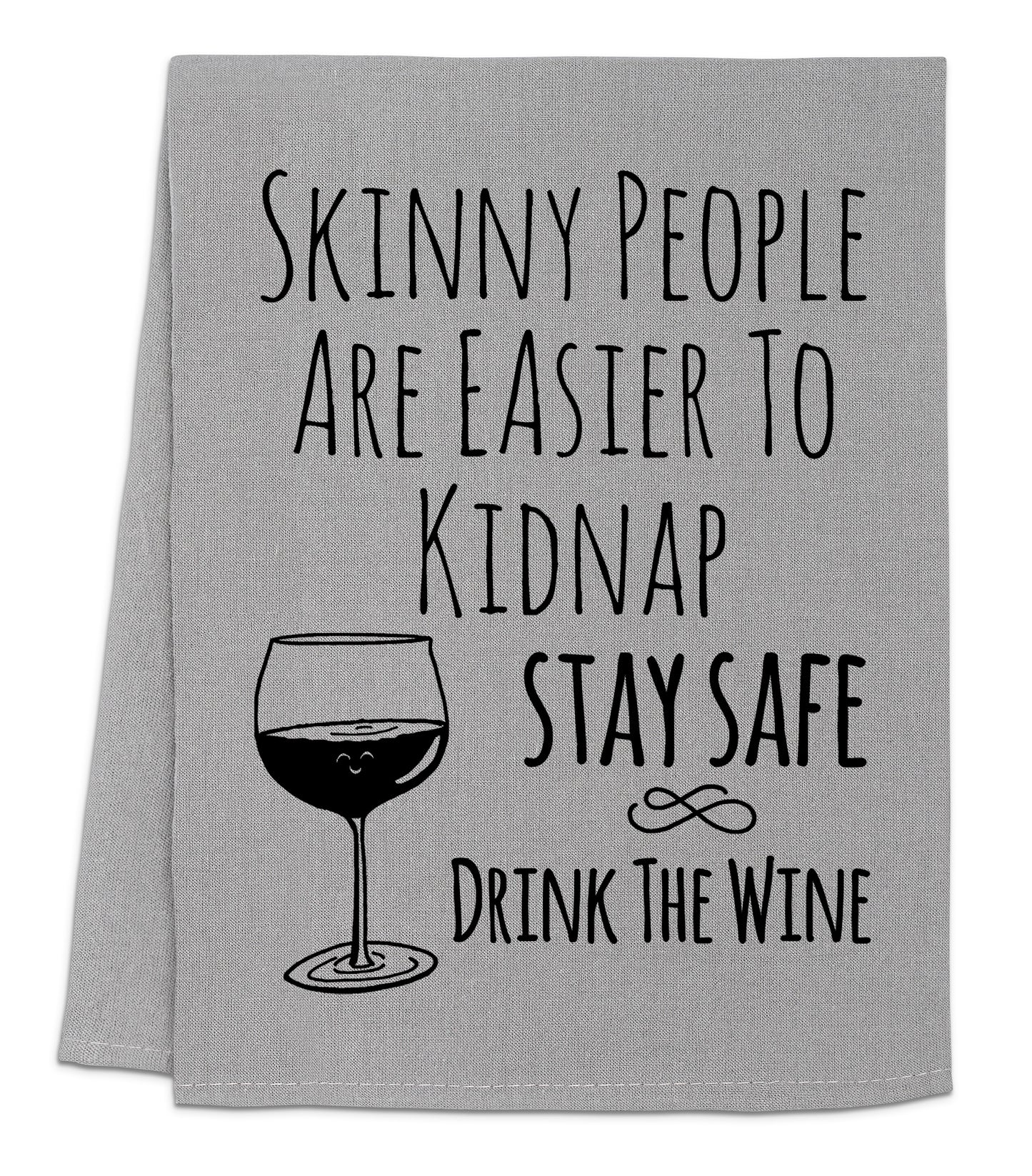 a towel that says skinny people are easier to kidnapped stay safe drink the wine