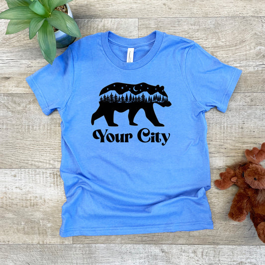 a blue t - shirt with a bear on it that says your city