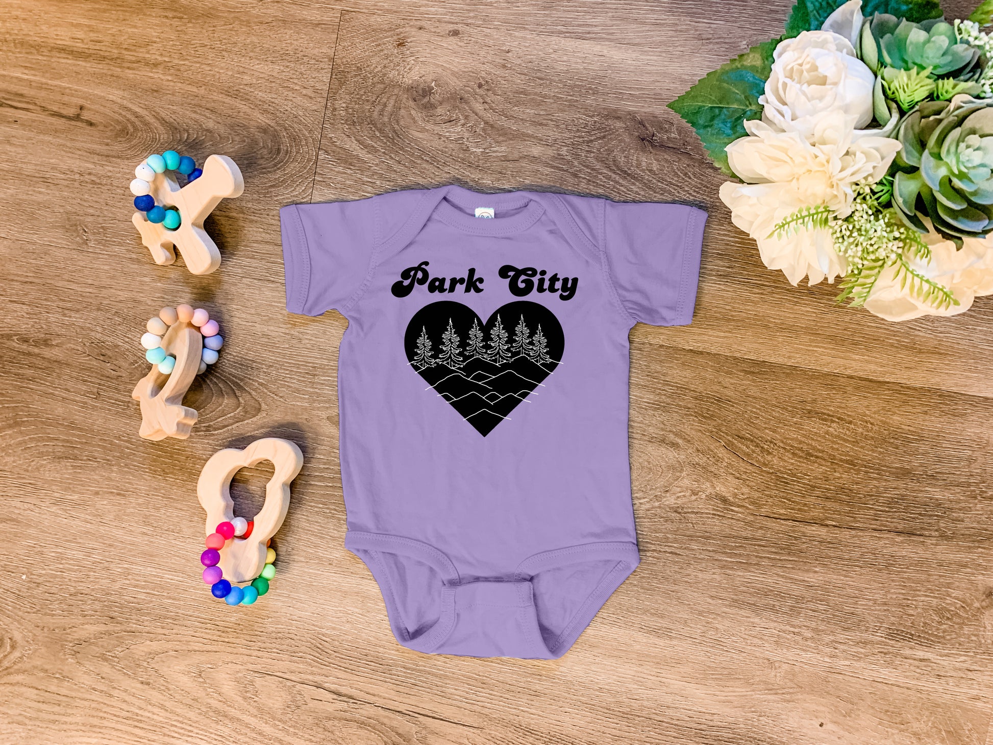 a baby bodysuit with the words park city printed on it