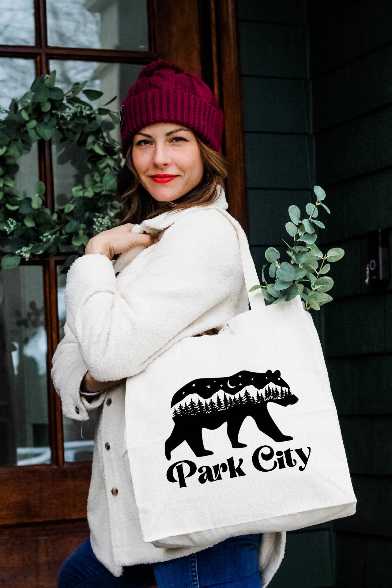 a woman carrying a bag that says park city