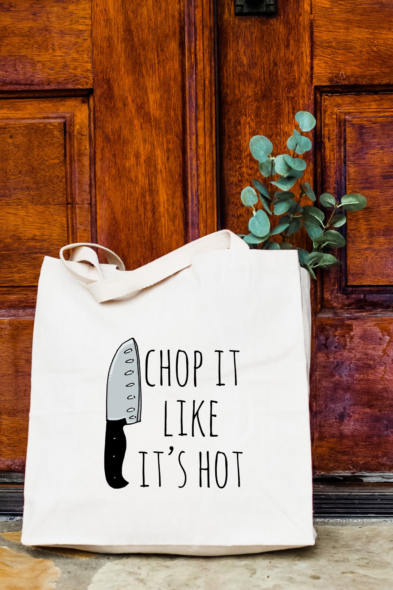 a tote bag with a knife printed on it