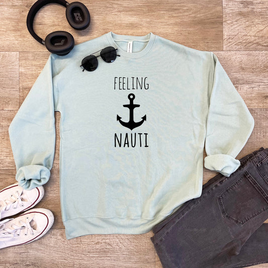 a sweater that says feeling nauti with a pair of headphones