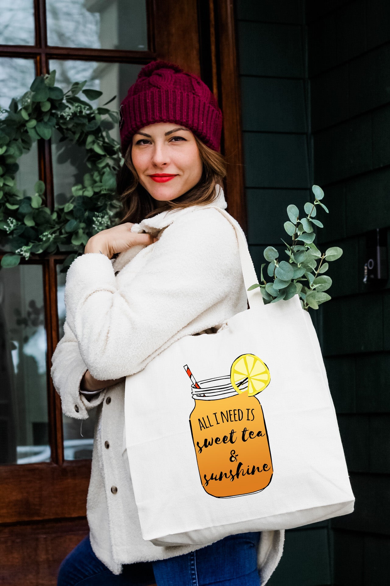 a woman holding a bag with a lemonade in it