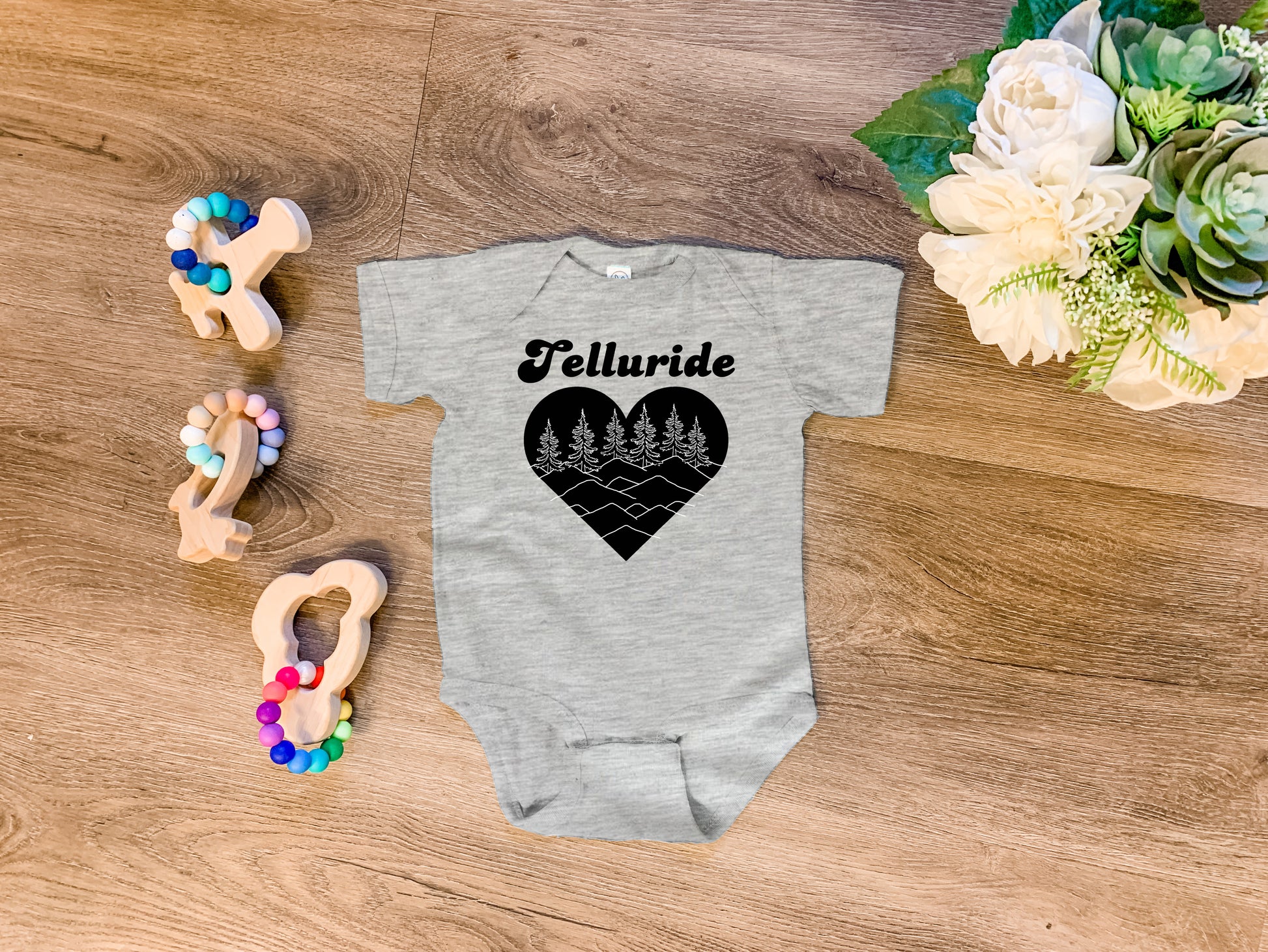 a baby bodysuit with the word telluride written on it