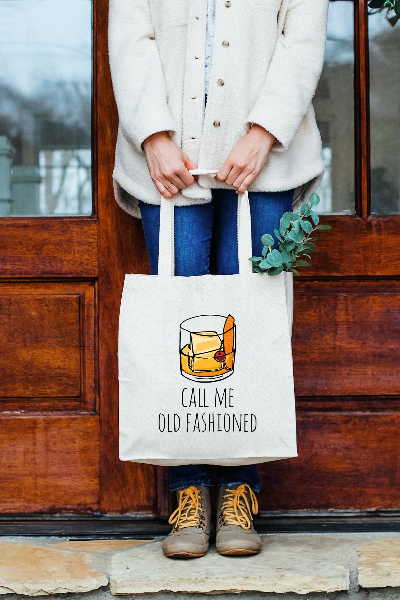 a woman holding a bag that says, call me old fashioned