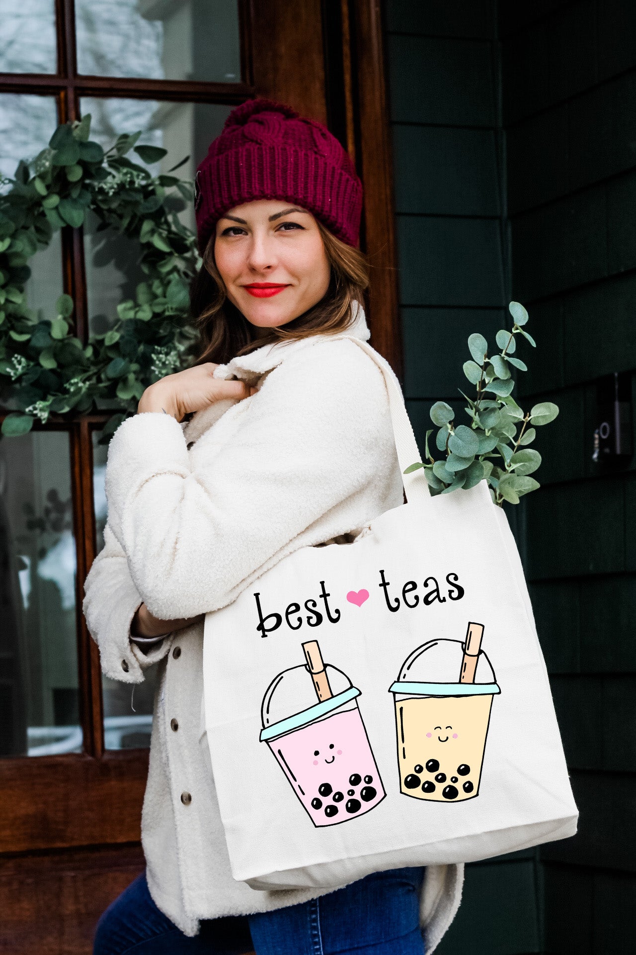 a woman carrying a bag that says best teas