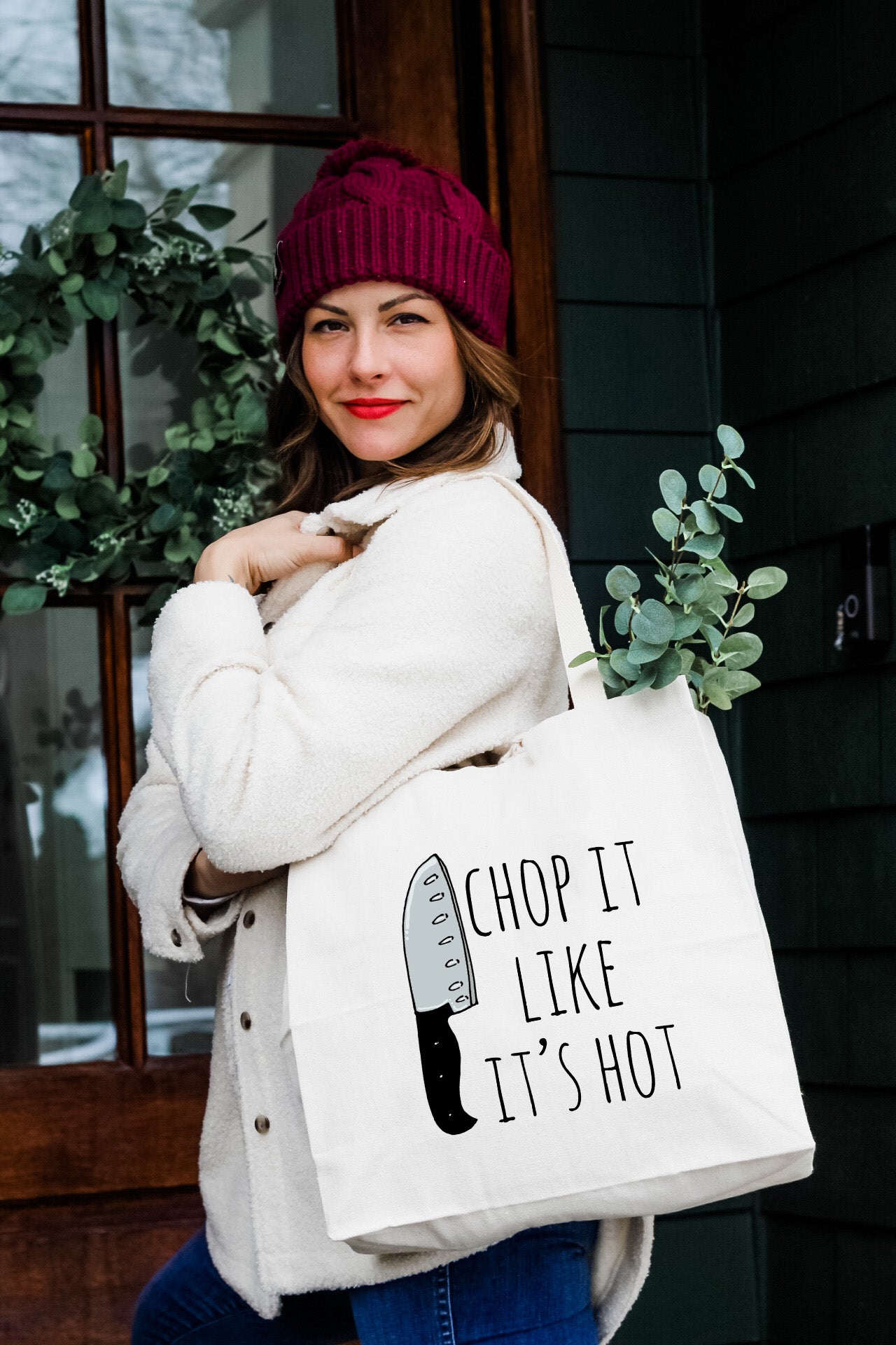 a woman carrying a shopping bag that says chop it like it's hot