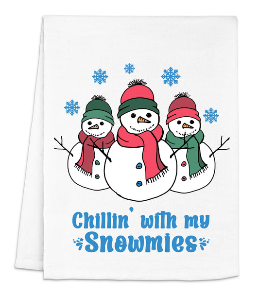 a white dish towel with three snowmen on it