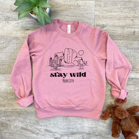 a pink sweatshirt that says stay cozy next to a teddy bear