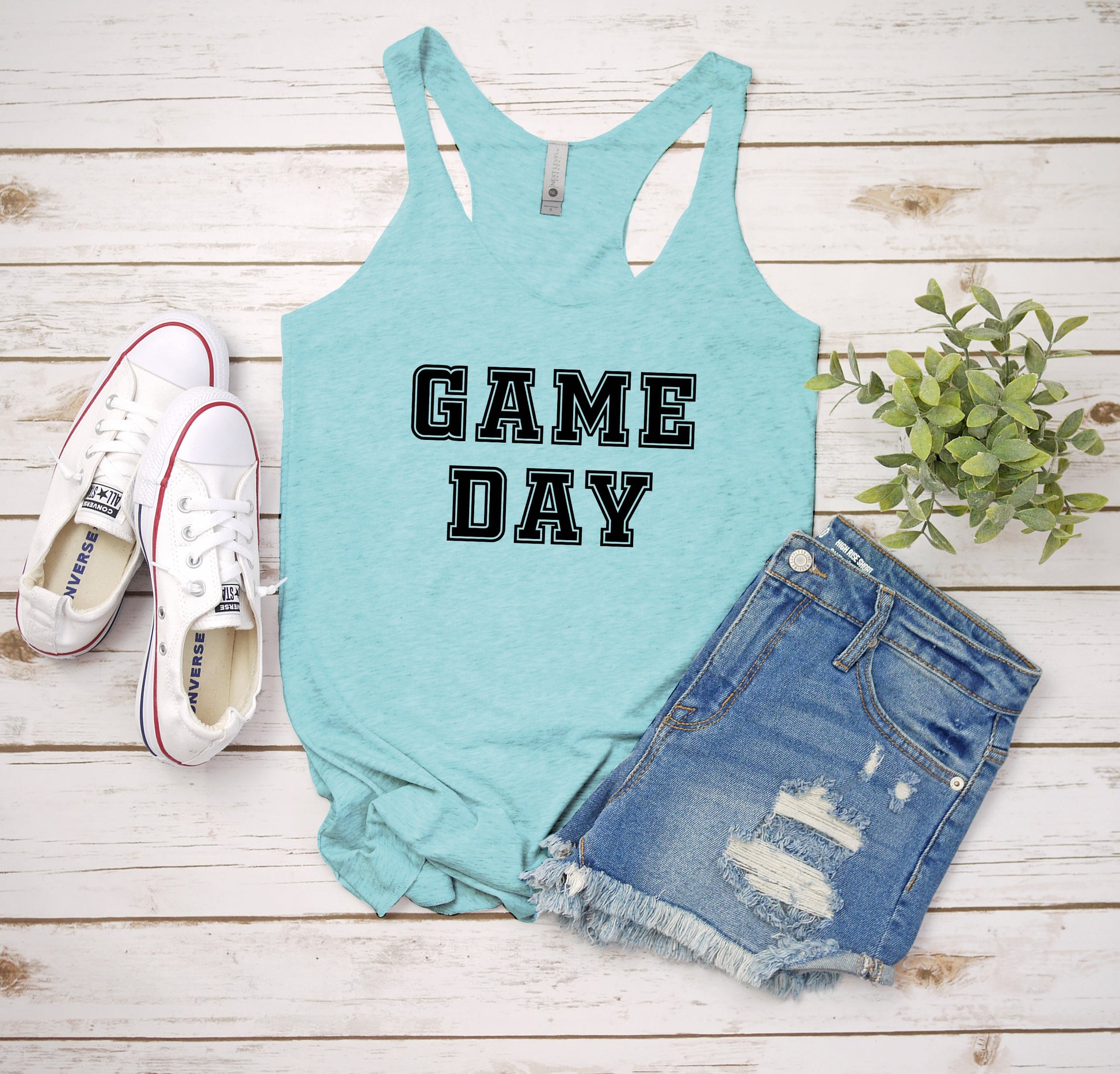 a tank top that says game day next to a pair of shorts