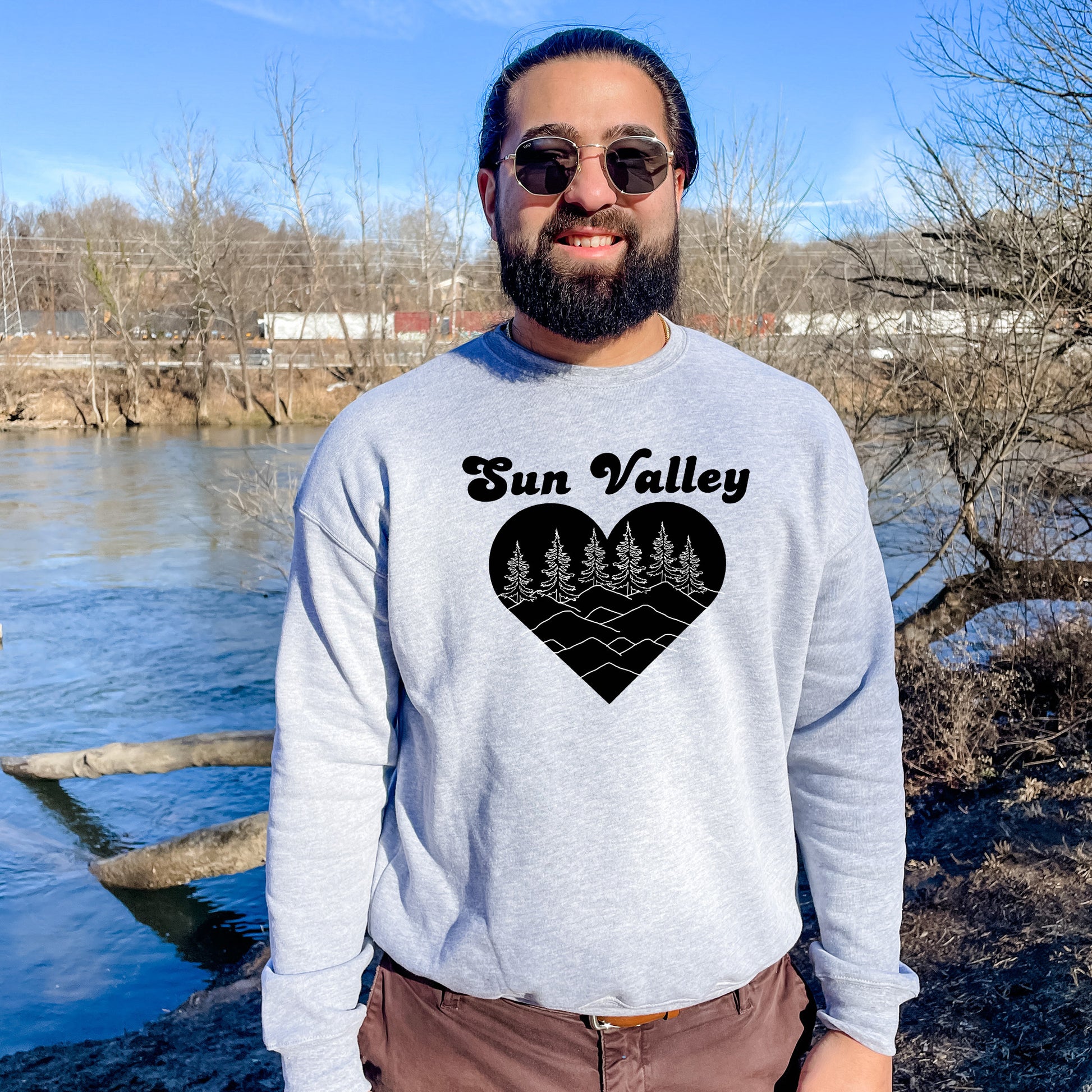 a man standing in front of a body of water