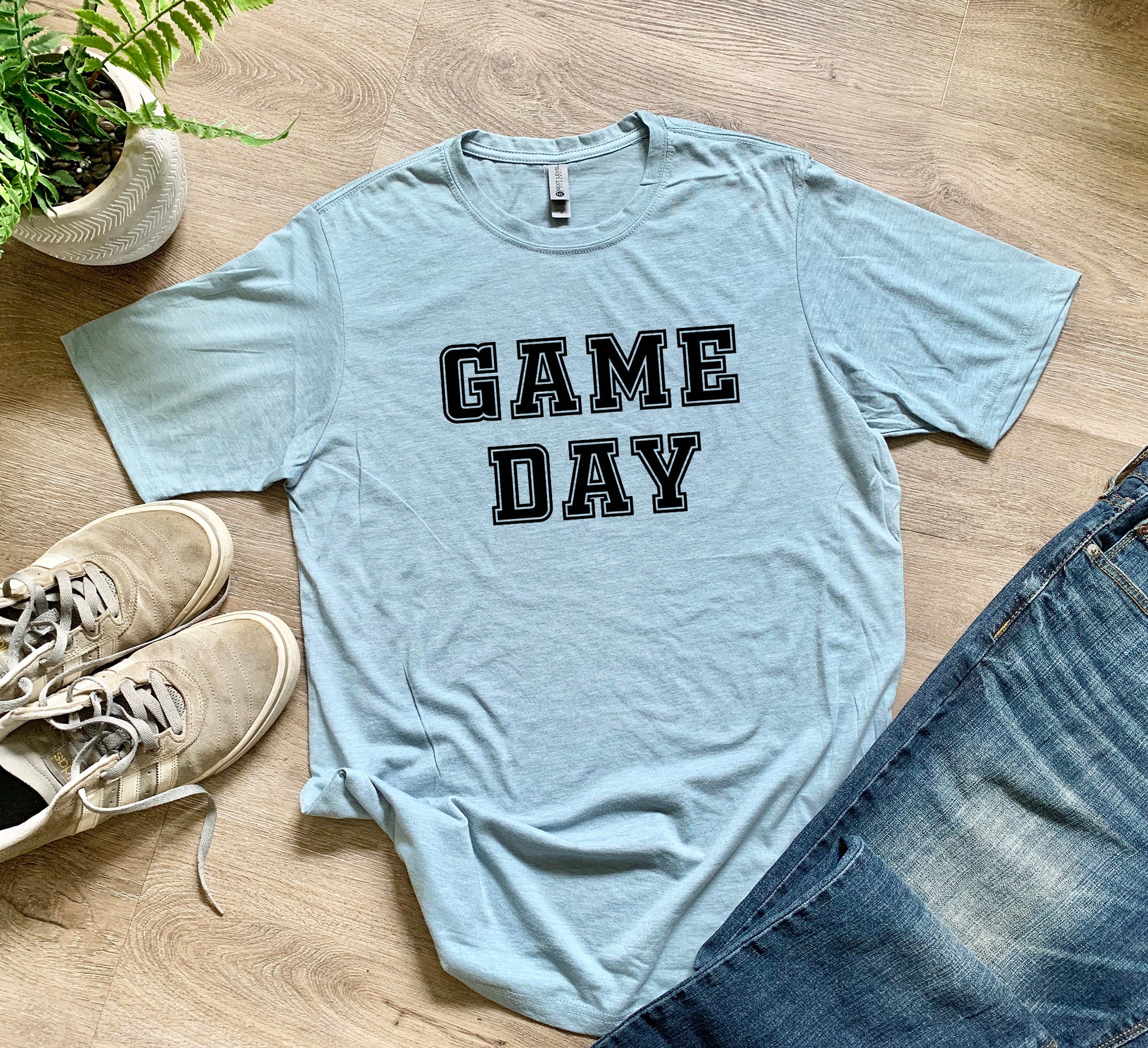 a t - shirt that says game day next to a pair of jeans