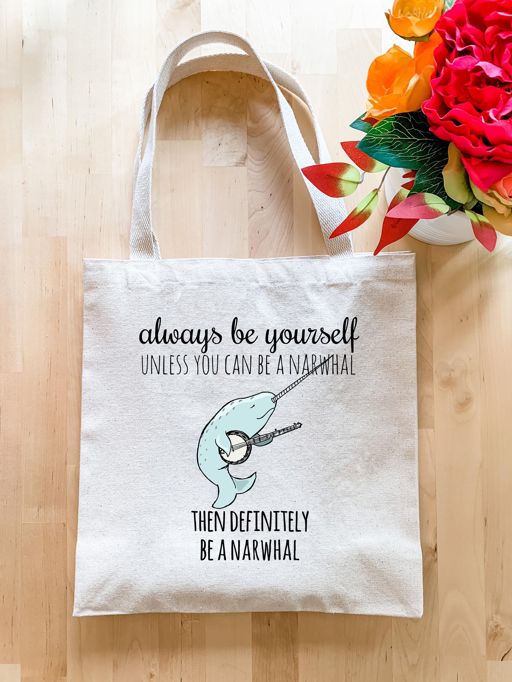 a tote bag with a picture of a narwhale on it