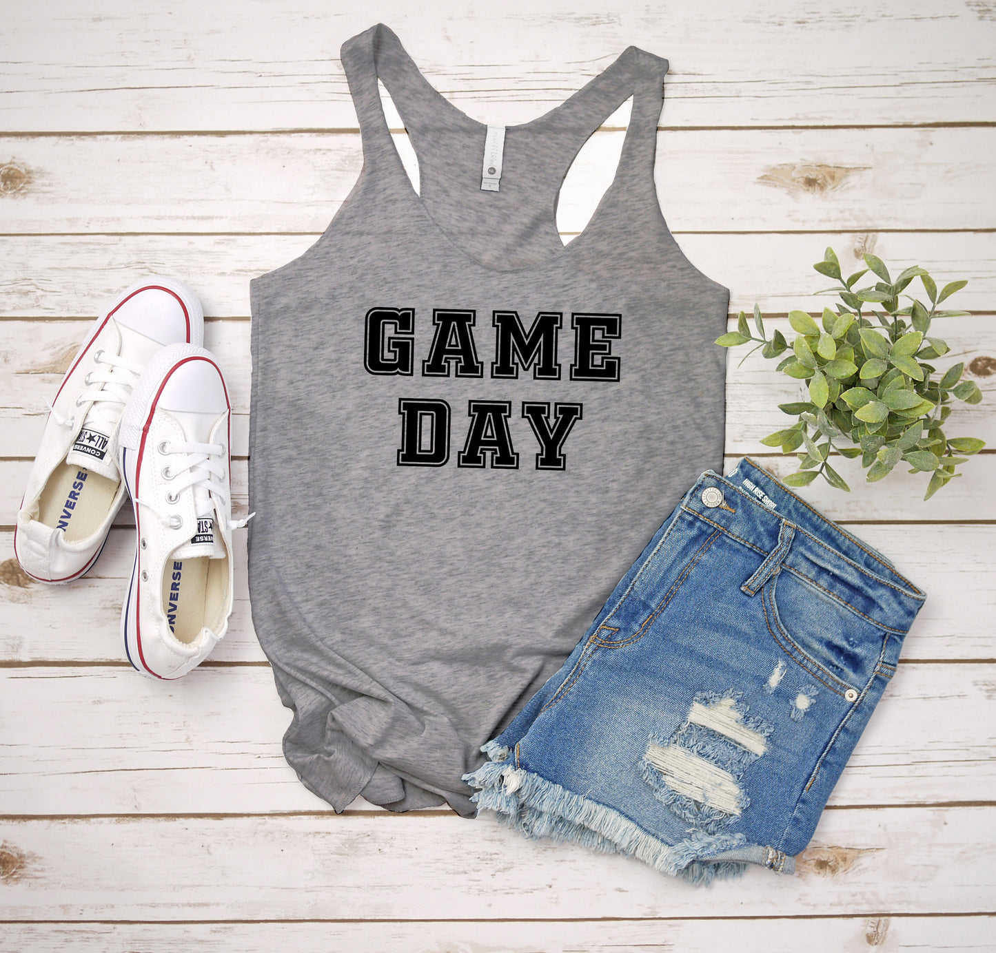 a tank top that says game day next to a pair of shorts