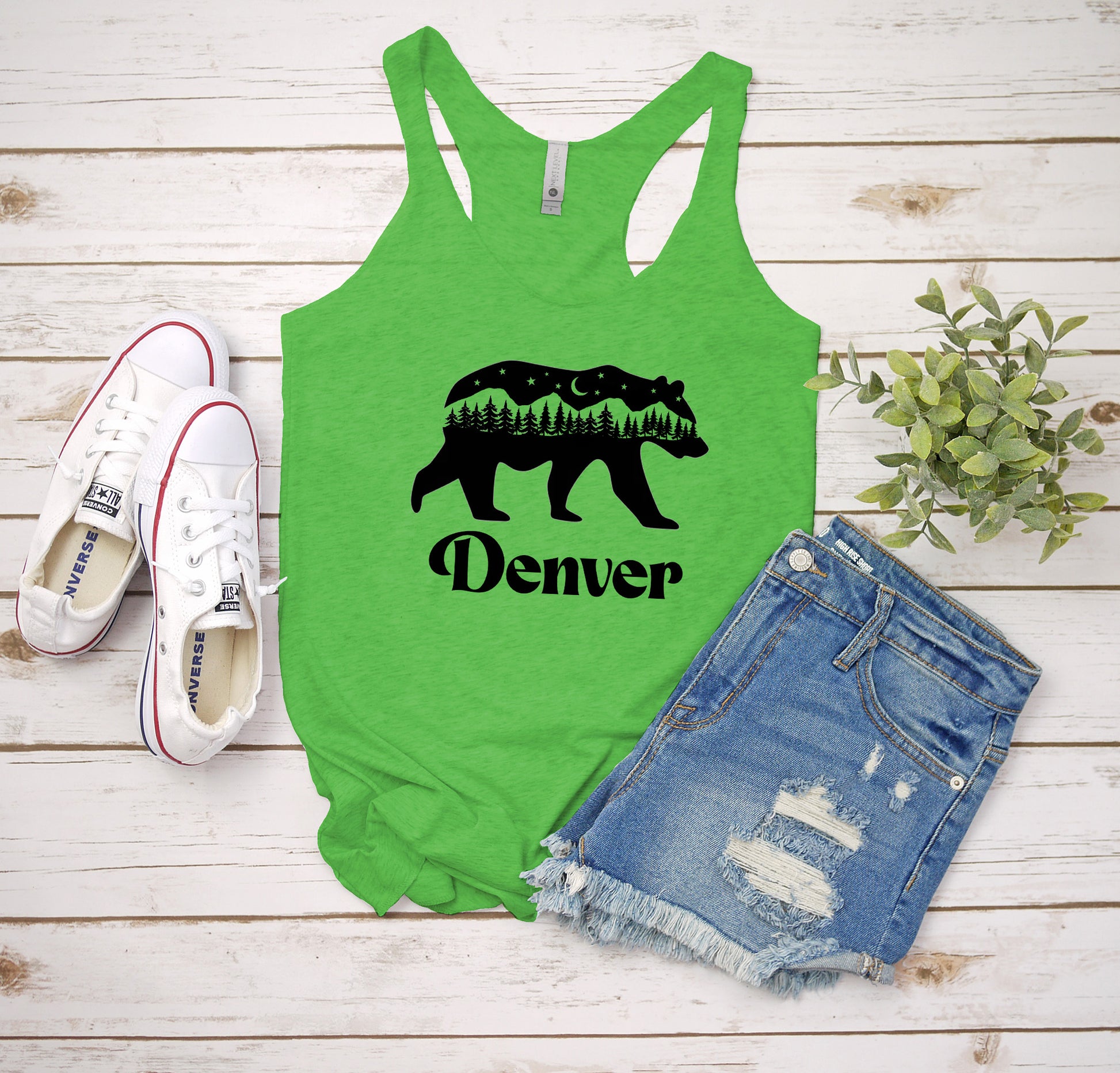 a green tank top with a bear and trees on it