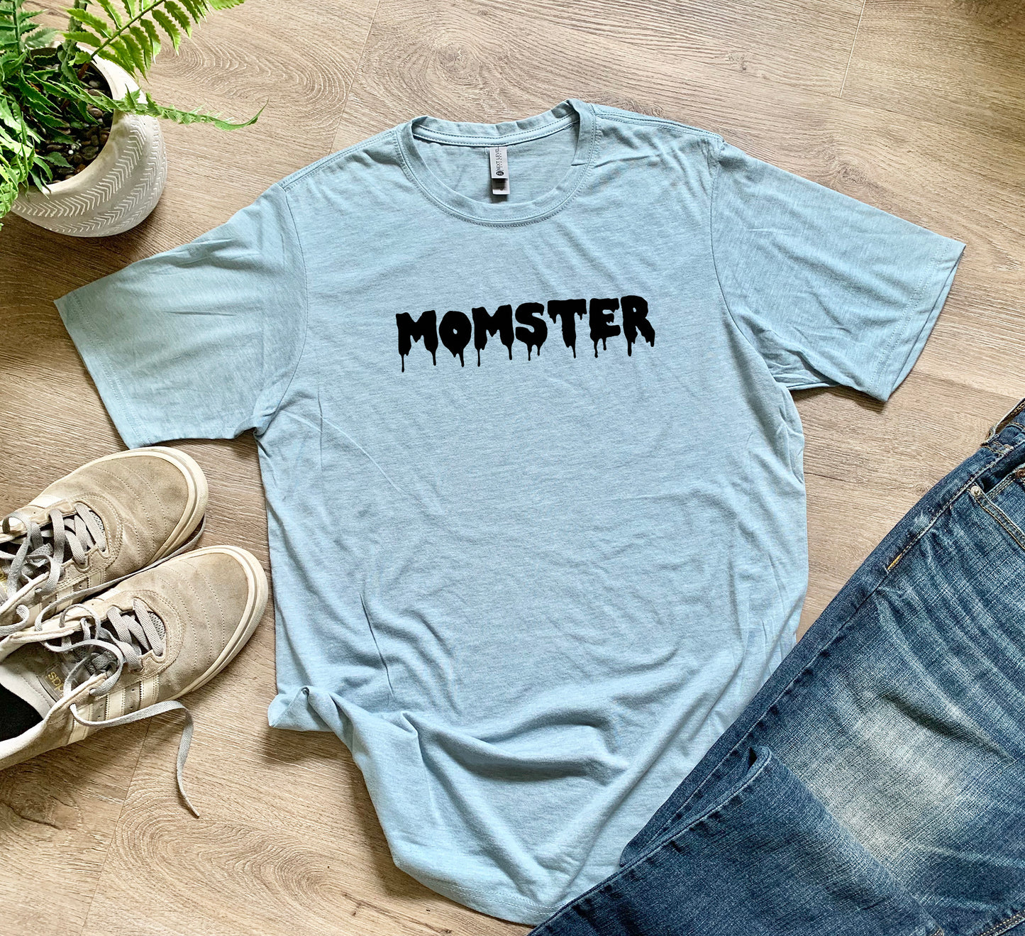 a t - shirt with the word monster on it next to a pair of jeans