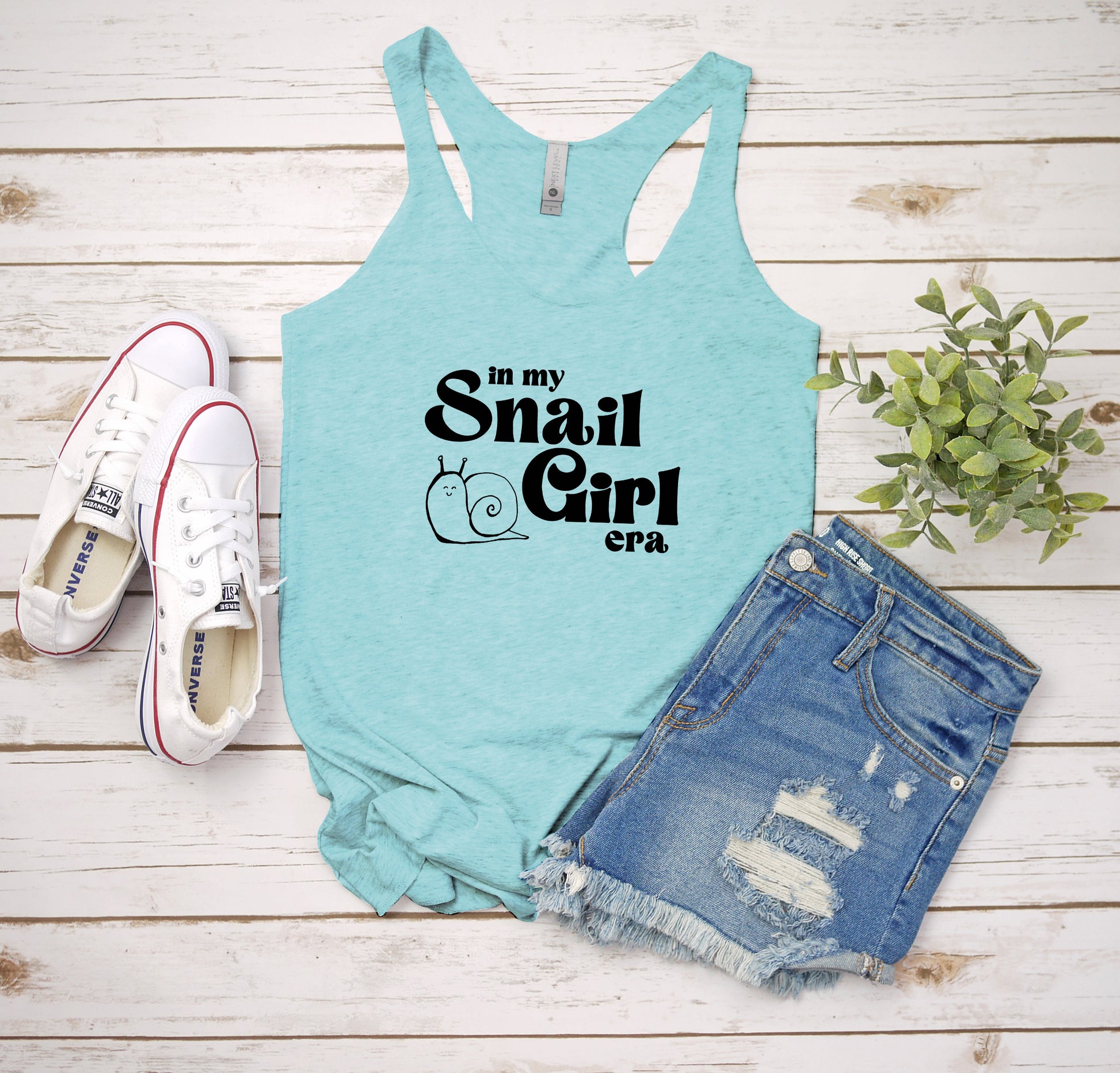 a tank top that says i'm my small girl next to a pair of