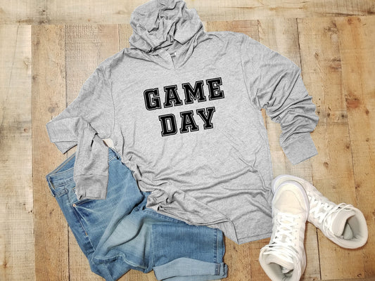 a hoodie that says game day next to a pair of jeans