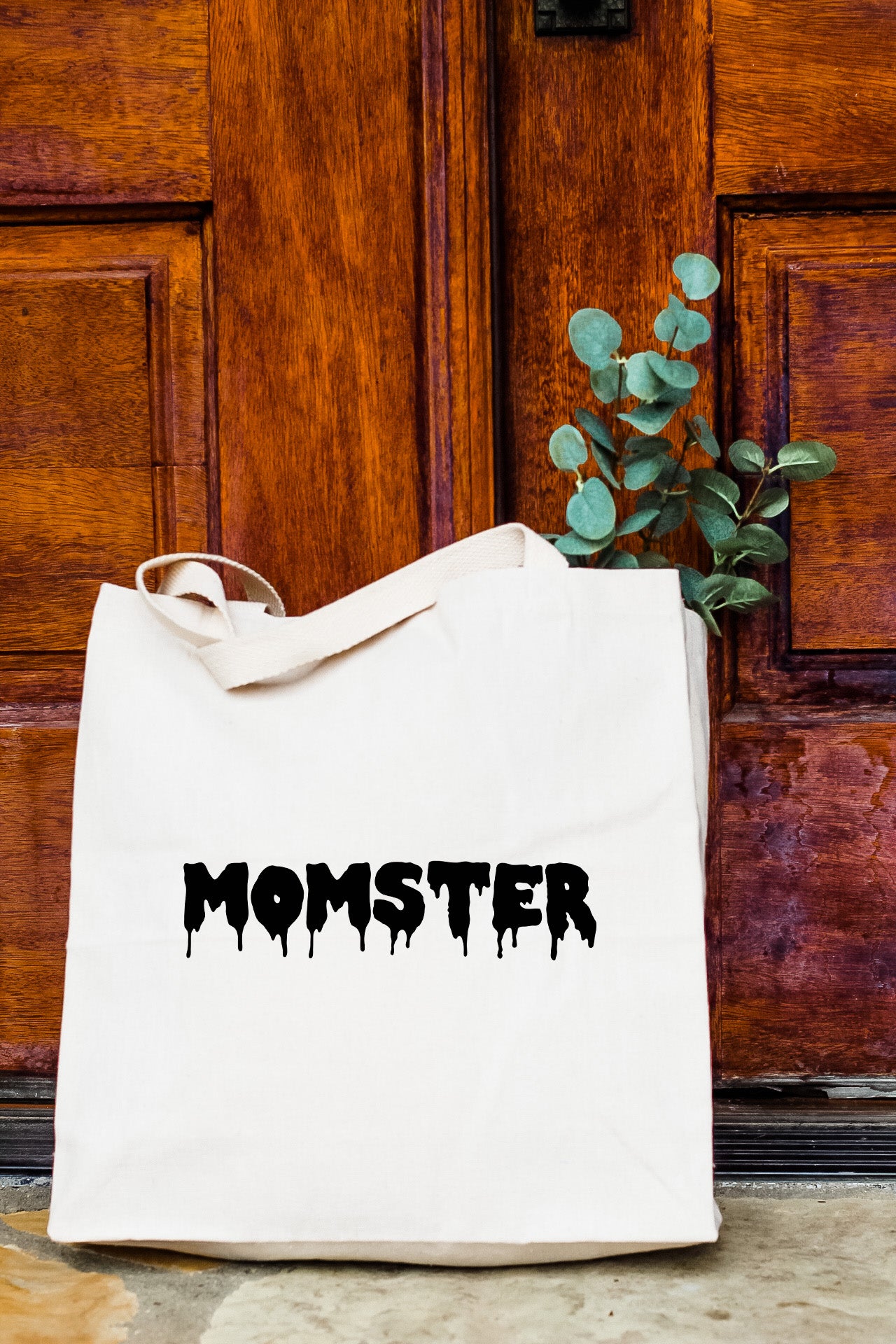 a white bag with the word monster printed on it