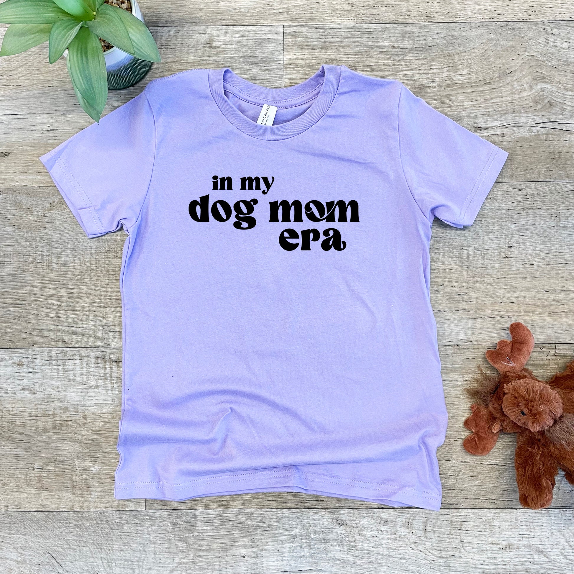 a t - shirt that says in my dog mom era next to a teddy bear