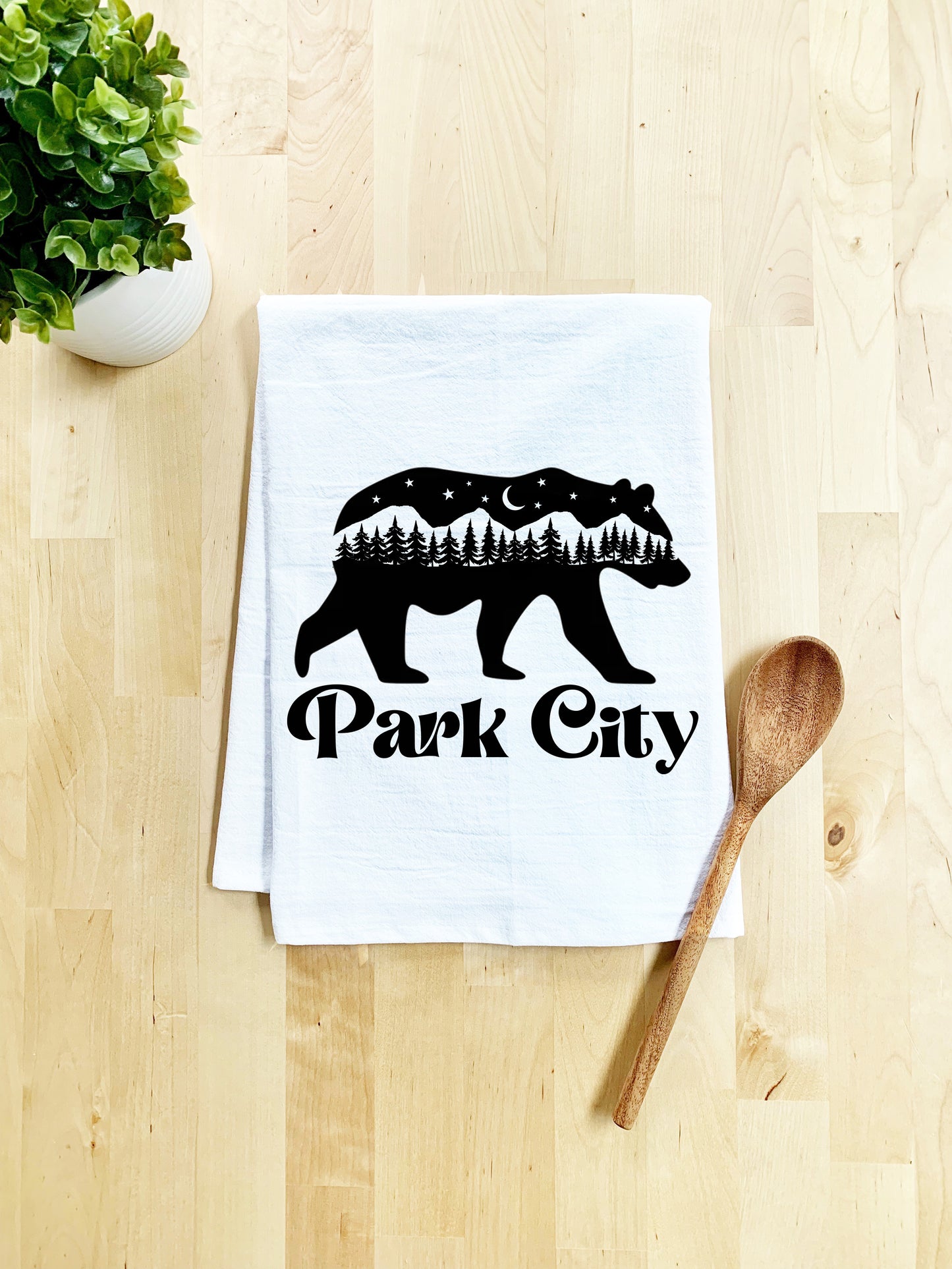 a tea towel that says park city with a bear on it