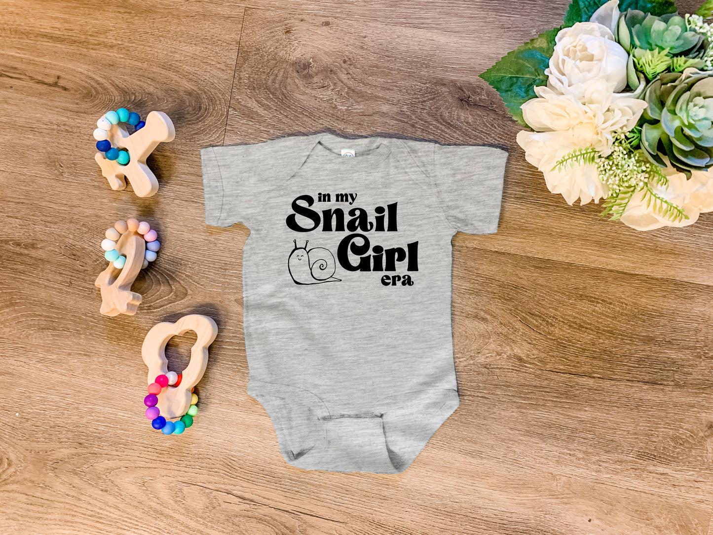 a baby bodysuit that says, i'm my small girl next to some