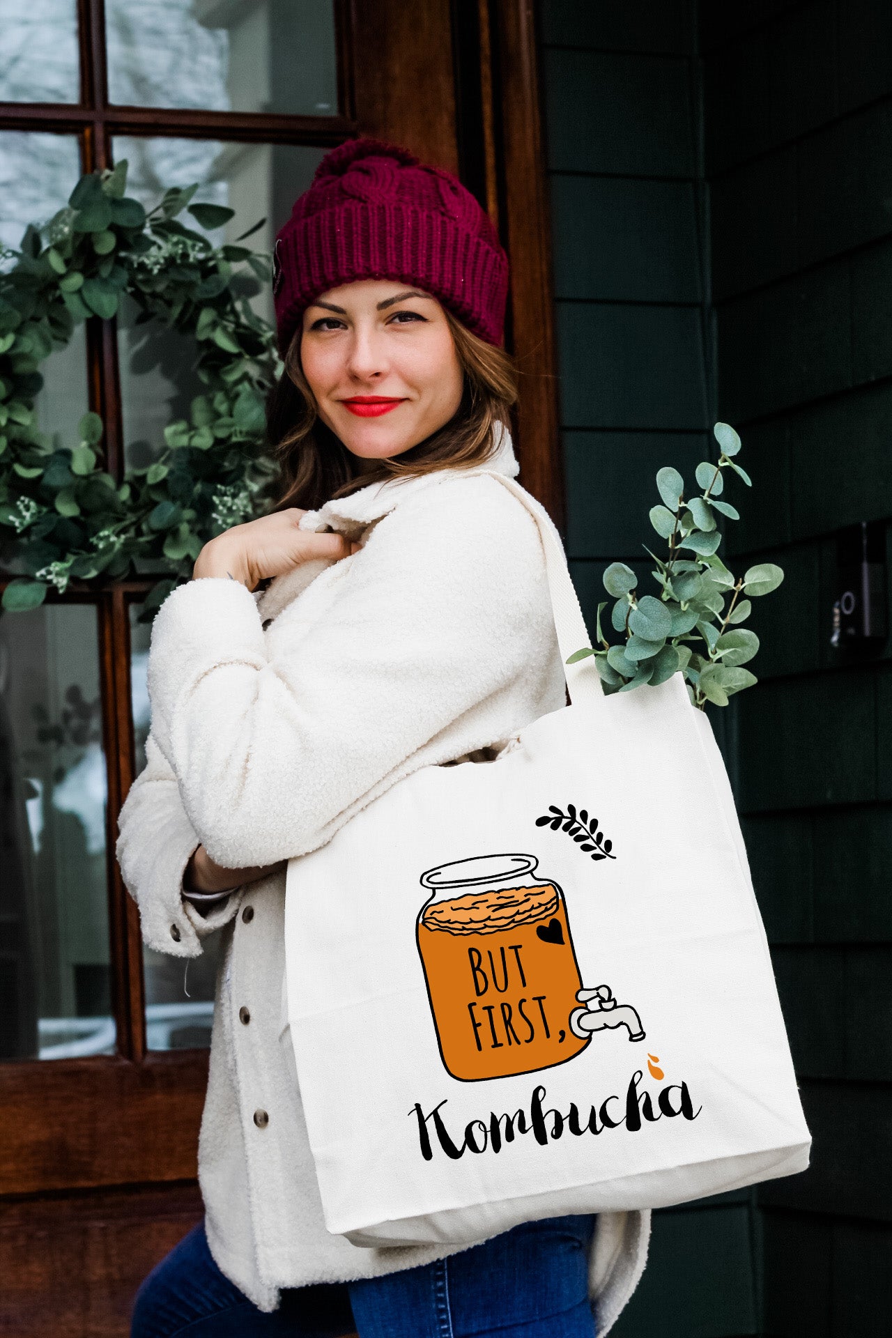a woman carrying a bag with a picture of a jar of honey