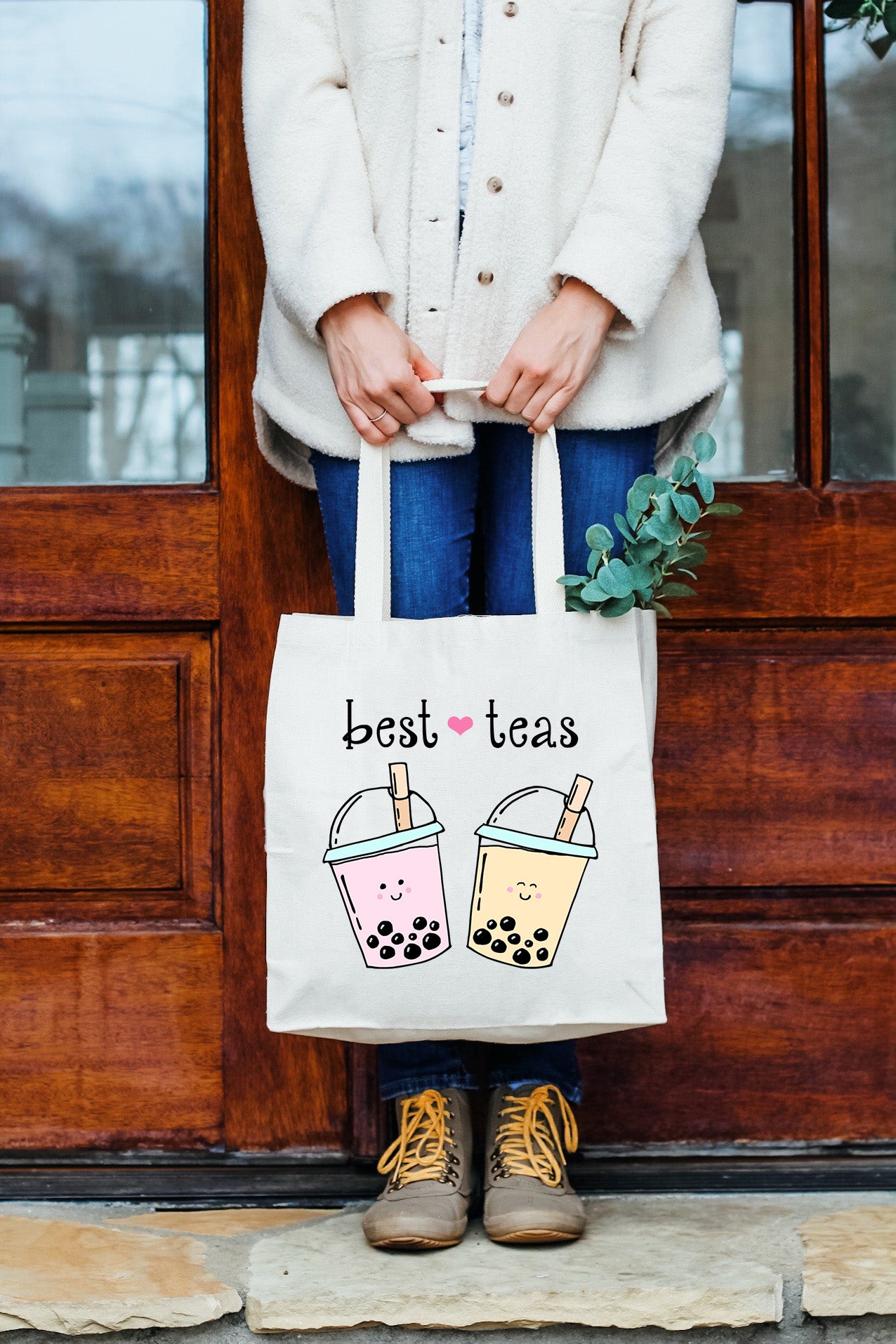 a woman holding a bag that says best teas