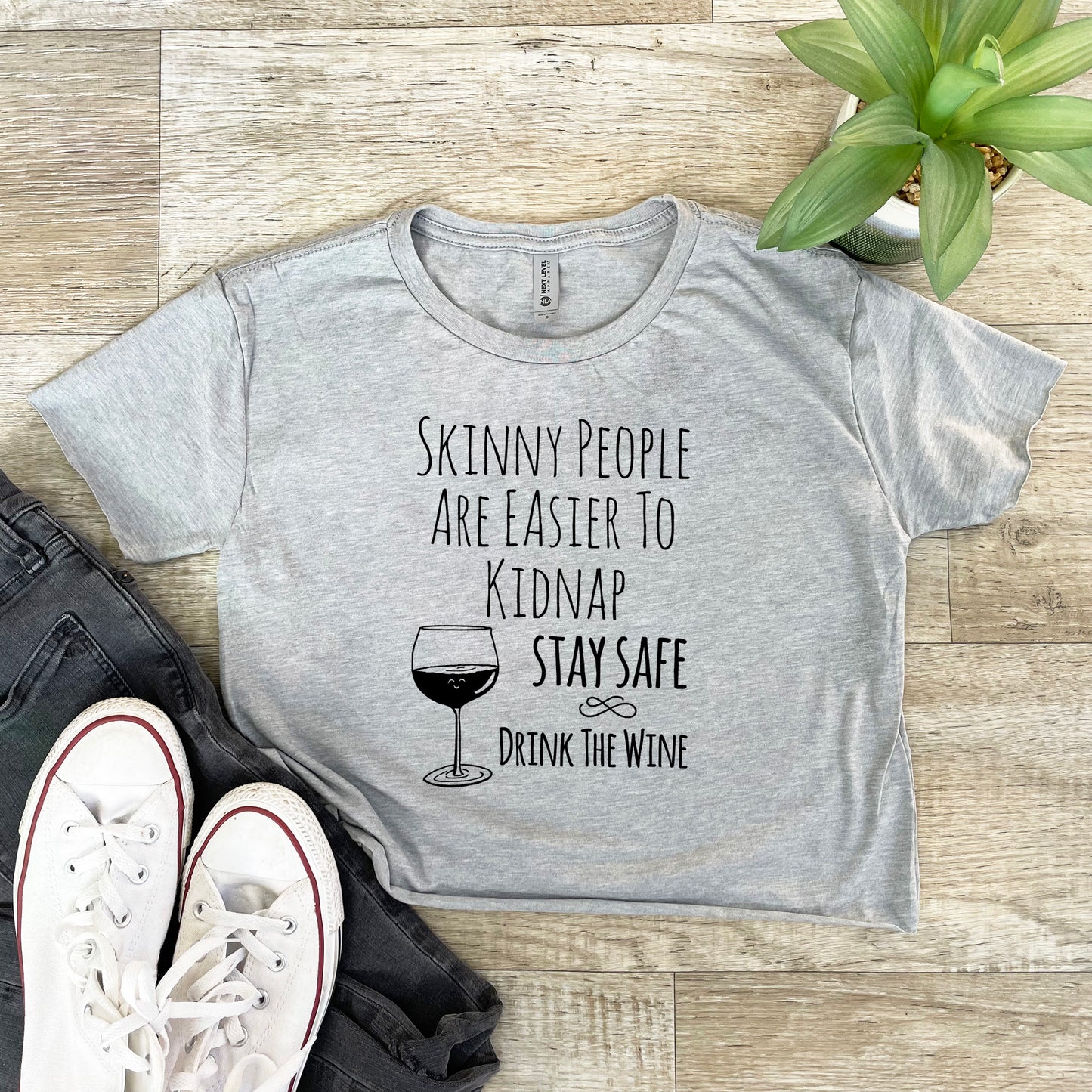 Skinny People Are Easier To Kidnap. Stay Safe. Drink The Wine - Women's Crop Tee - Heather Gray or Gold